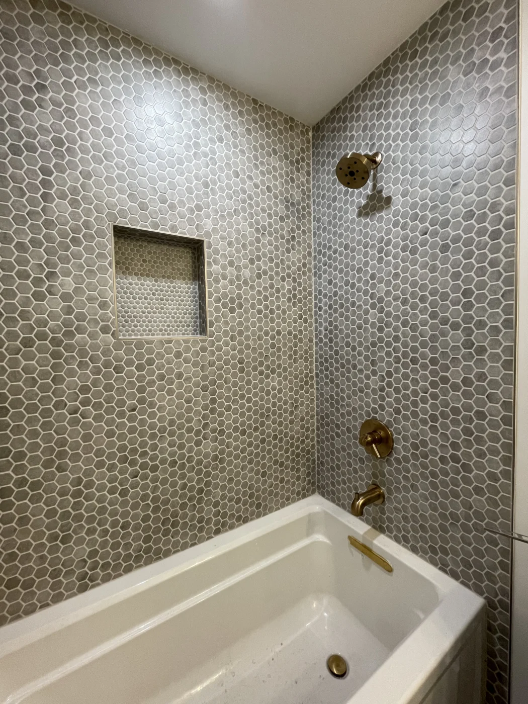 Vertical drain pipe and basement plumbing installed near a foundation wall