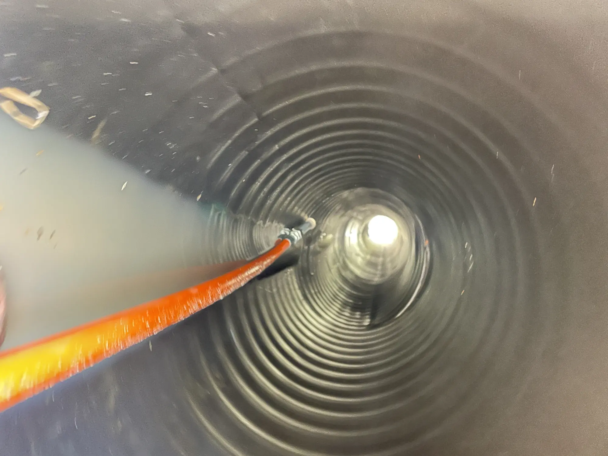 Red and blue PEX plumbing lines installed neatly along a basement wall