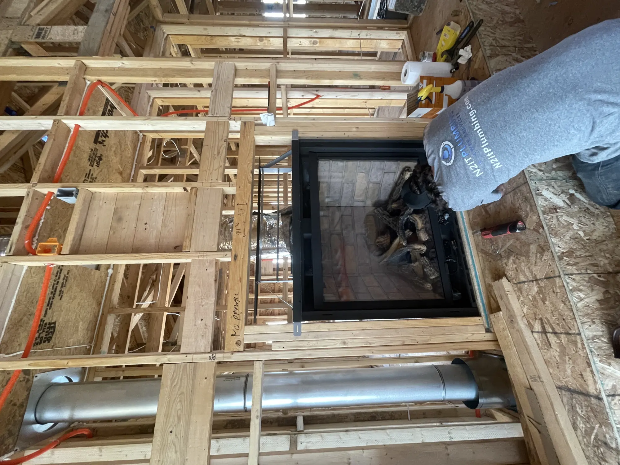 Framed interior wall with venting and plumbing work during a remodel