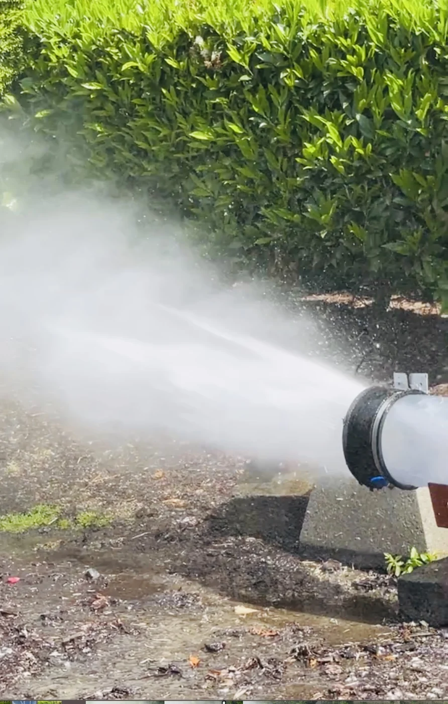 High-pressure jetting spray clearing an outdoor drain or sewer line