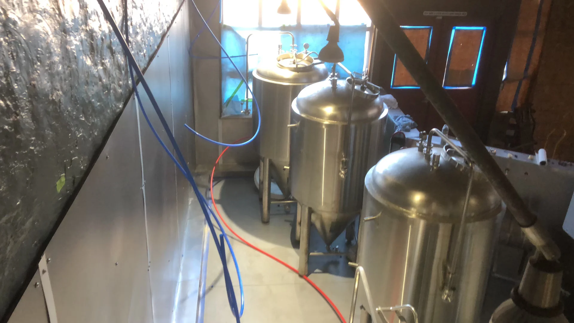 Whole-home water filtration tanks installed in a utility area